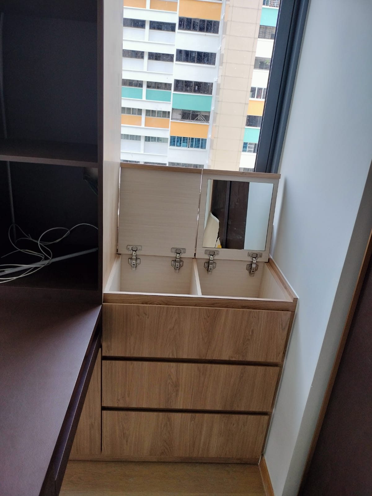 Custom dresser with drawers beside a mirror