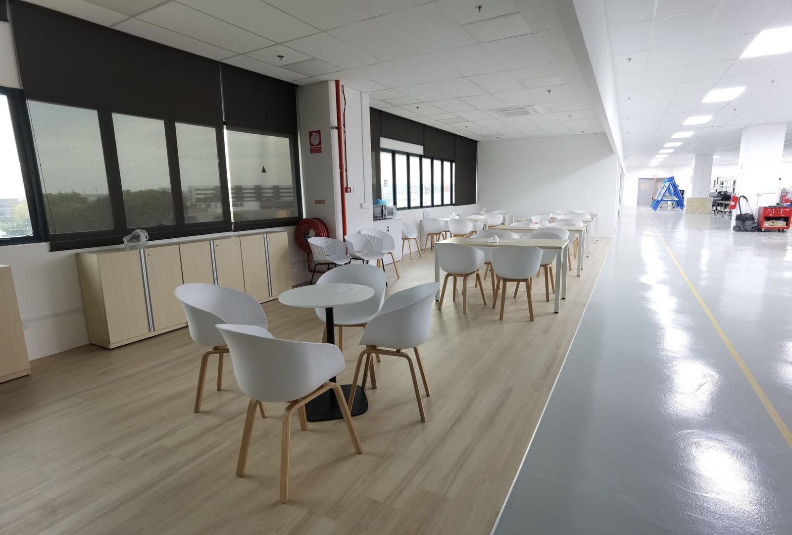 Office pantry counter and stools, with the workshop corridor beyond
